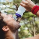 5 smart dieting resolutions for the New Year.Close up of man drinking water